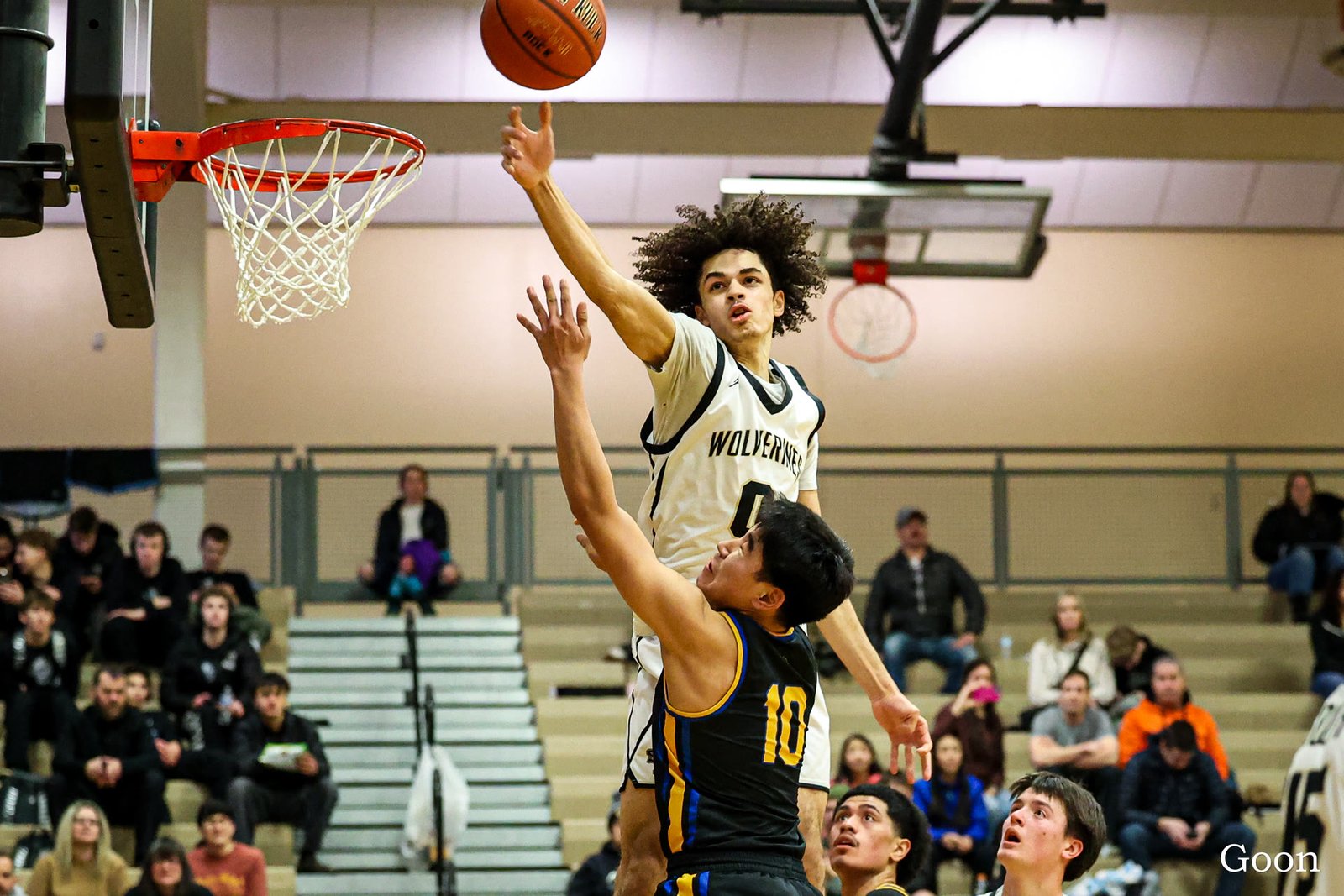 A South Anchorage Wolverine blocking a shot at the rim against Barrow in the Wolverine Classic