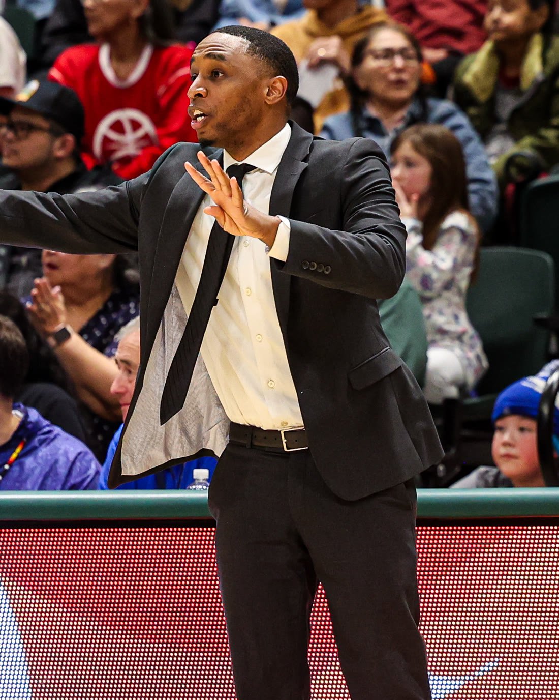 Coach Jamaal Siah directing the team from the sideline at the state championship