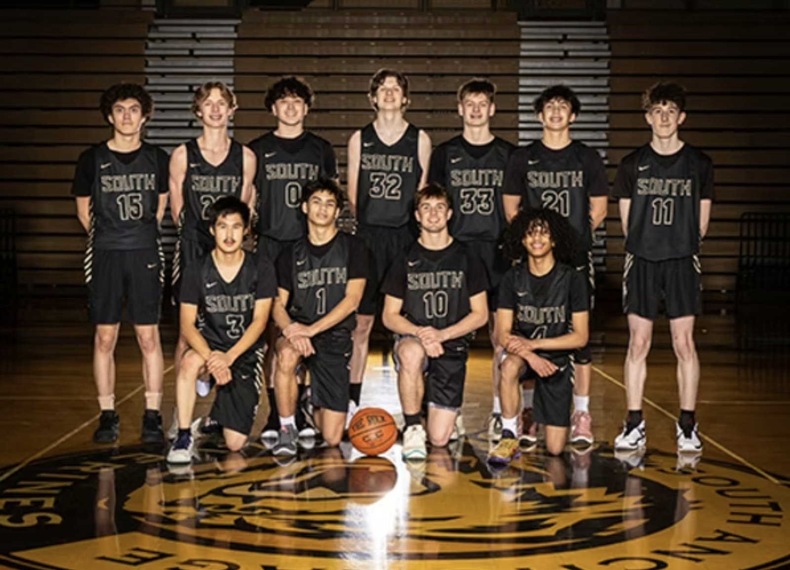 The South Anchorage junior varsity boys basketball team on the centre court crest