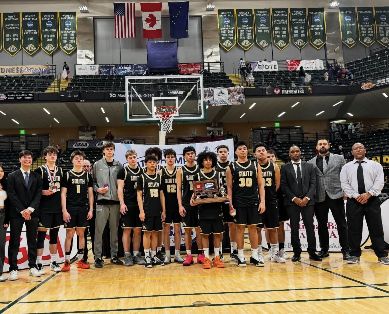 The South Anchorage team and coaching staff lined up on court at the state tournament